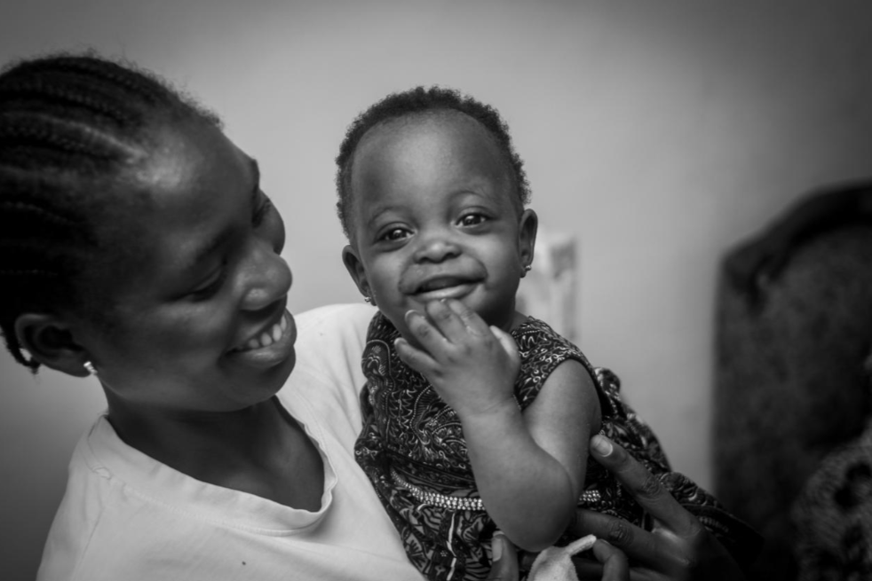 A smiling mother holding her baby